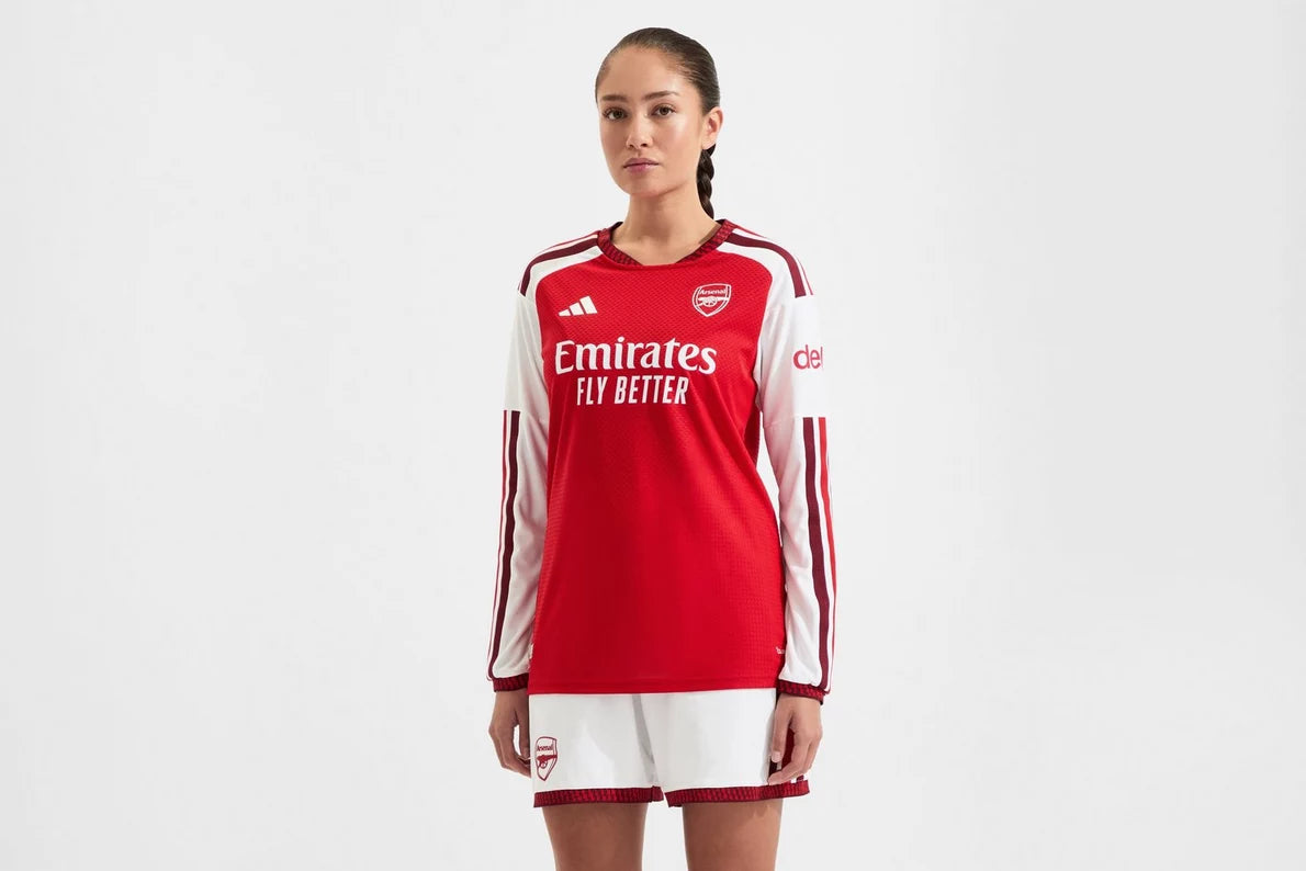 Person wearing a red and white sports jersey with visible branding on a white background