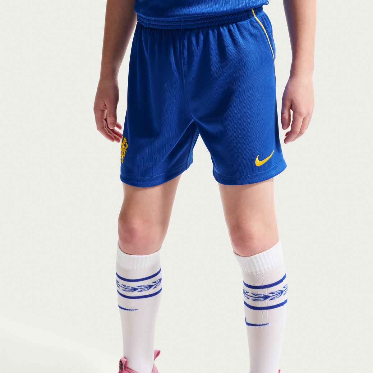 Person wearing blue shorts with a Nike logo on a white background
