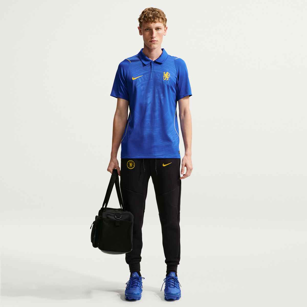 Person wearing a blue sports outfit with Nike logo on a white background