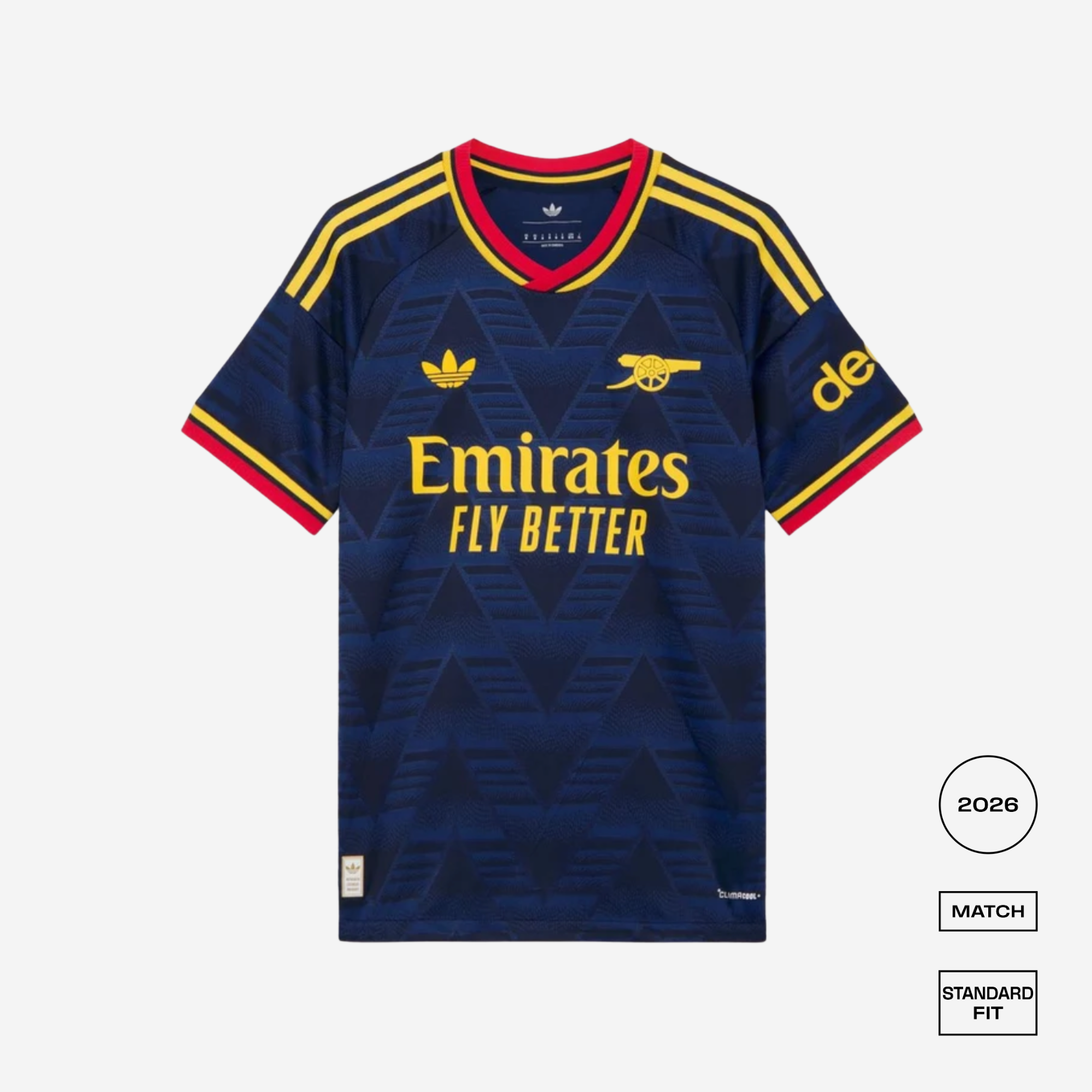 A dark navy blue Arsenal football jersey with yellow and red accents, featuring the Adidas logo, Arsenal cannon crest, Emirates Fly Better sponsor, and a 'de' sponsor logo on the sleeve. The jersey is displayed on a light gray background with fit and year badges on the bottom right.