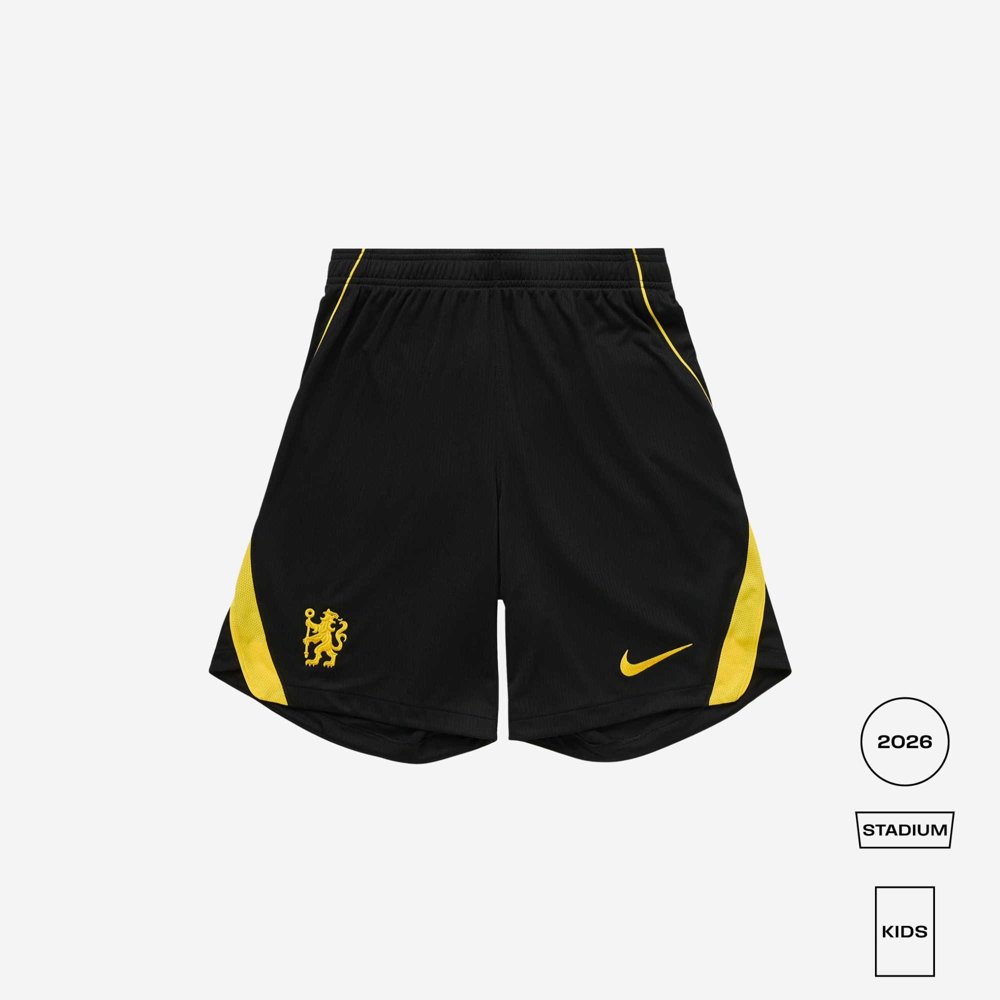 Black Nike soccer shorts with yellow side panels, a yellow Nike swoosh, and a yellow lion crest on the left leg, shown on a light gray background with 2026 Stadium Kids branding.