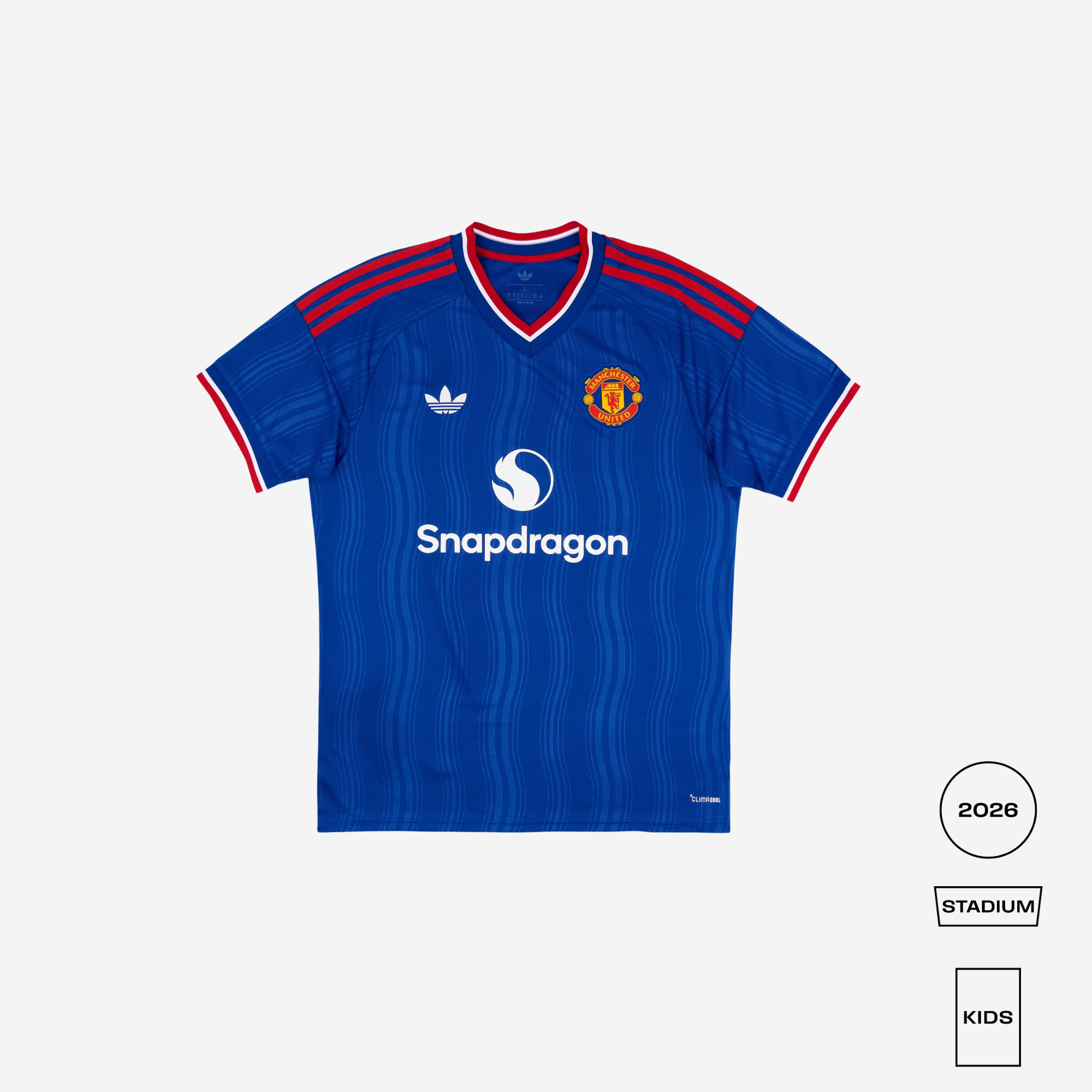 A blue Manchester United soccer jersey by Adidas, featuring red and white trim on the V-neck and sleeve cuffs, with the Snapdragon sponsor logo on the chest. The image is set against a light gray background with size and style indicators in the bottom right corner.