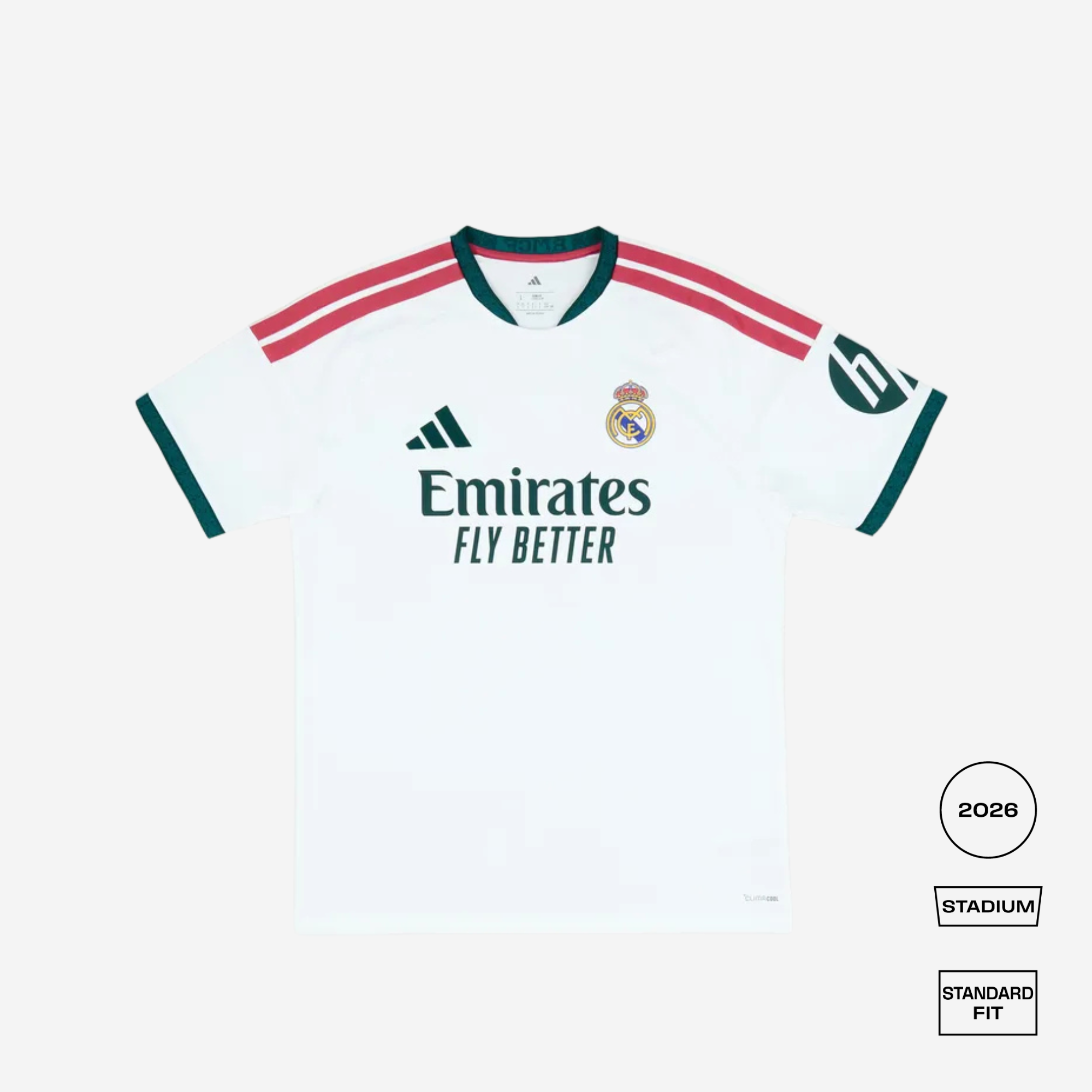 A white Real Madrid 2026 stadium soccer jersey with green and red accents, featuring the Adidas logo, Real Madrid crest, and Emirates Fly Better sponsor text, shown on a light gray background with fit and style labels.