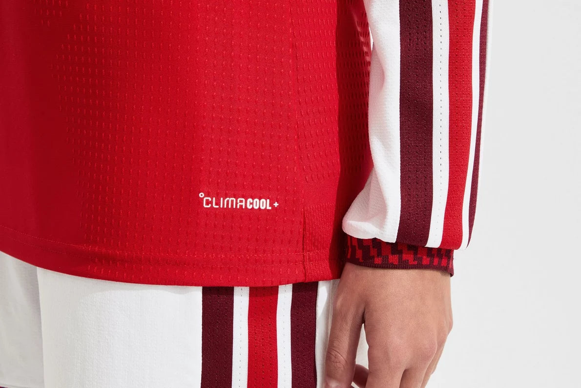 Red sports jersey with 'Climacool' logo on a white background