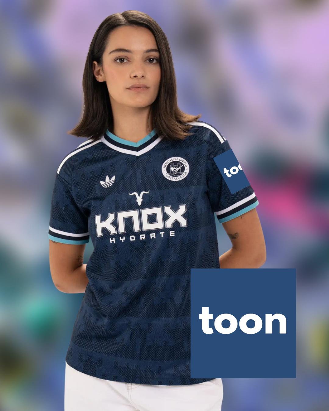 A woman wearing a dark navy blue soccer jersey with white and light blue accents, featuring the Adidas logo, a circular crest, and 'KNOX HYDRATE' sponsor text. A blue 'toon' logo overlay is in the bottom right corner.